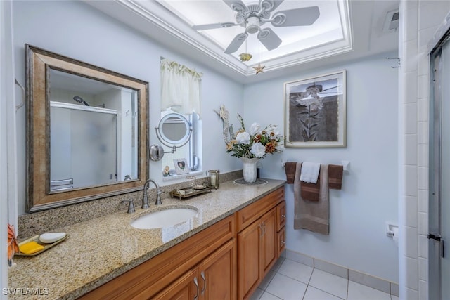 bathroom featuring vanity, an enclosed shower, tile patterned flooring, a tray ceiling, and ceiling fan