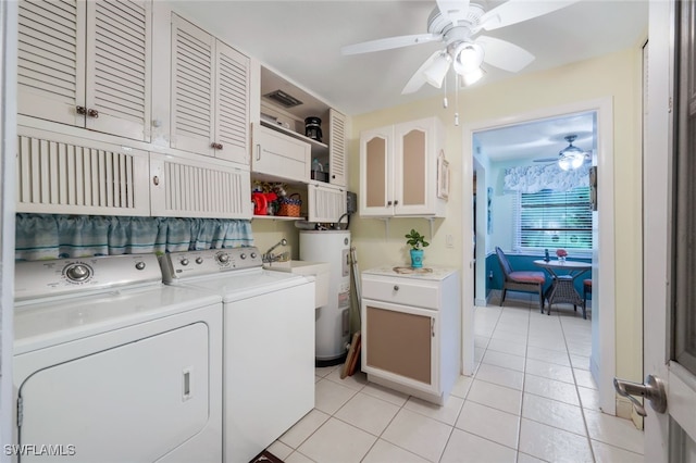 washroom with washer and clothes dryer, light tile patterned floors, water heater, cabinets, and ceiling fan