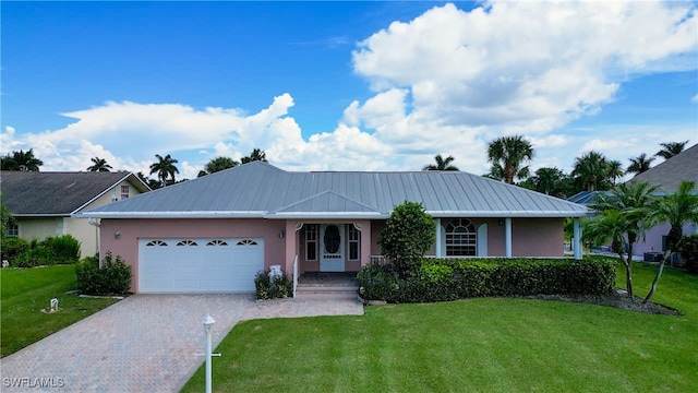 ranch-style home with a garage and a front lawn