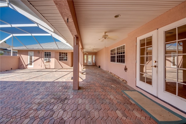 view of patio / terrace featuring ceiling fan, french doors, and a lanai