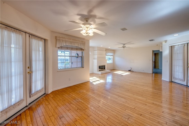 unfurnished living room with ceiling fan and light hardwood / wood-style flooring