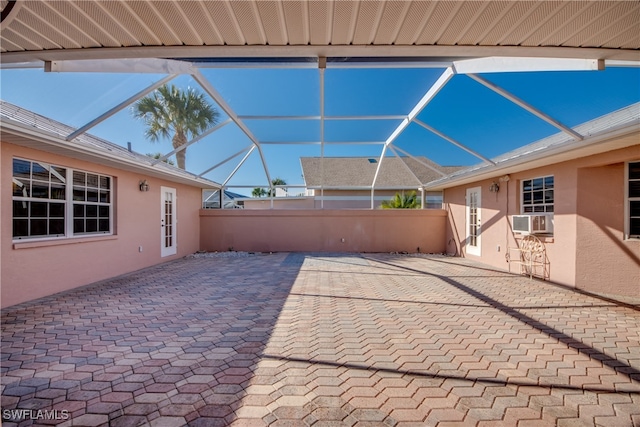 view of patio / terrace featuring cooling unit and a lanai