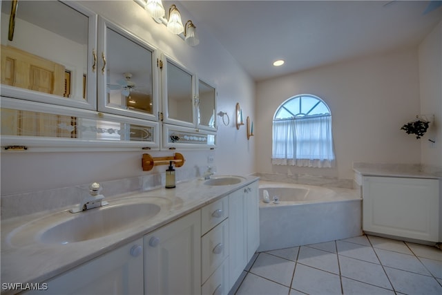 bathroom with a tub to relax in, tile patterned flooring, and vanity