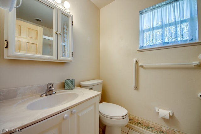 bathroom featuring vanity, toilet, and tile patterned floors