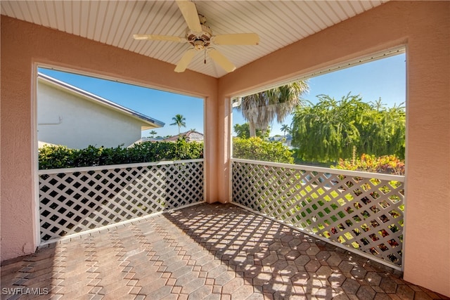 view of patio with a balcony and ceiling fan