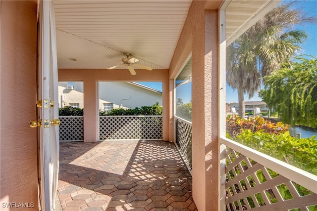 view of patio featuring ceiling fan and a balcony