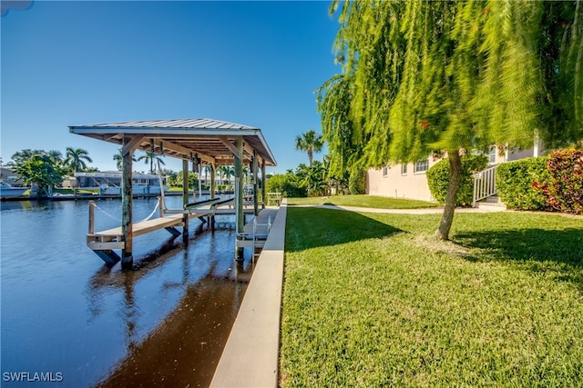 view of dock featuring a water view and a yard