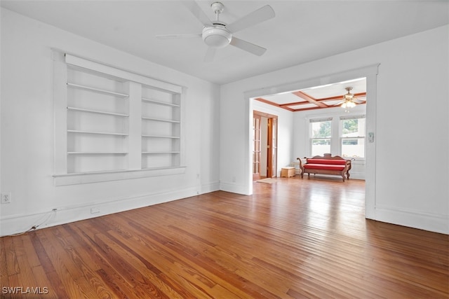 spare room with ceiling fan, hardwood / wood-style floors, and built in features