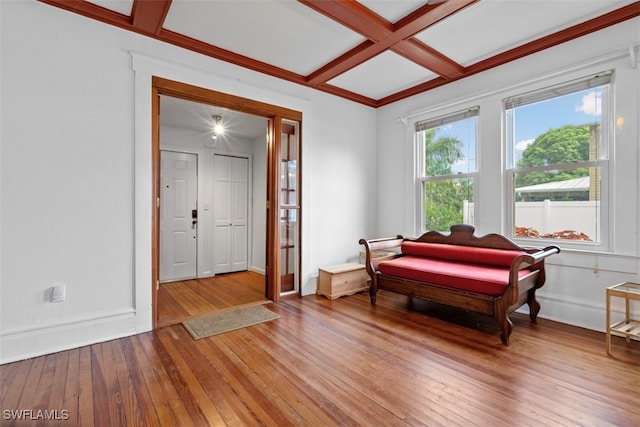 living area featuring beamed ceiling, coffered ceiling, and hardwood / wood-style flooring