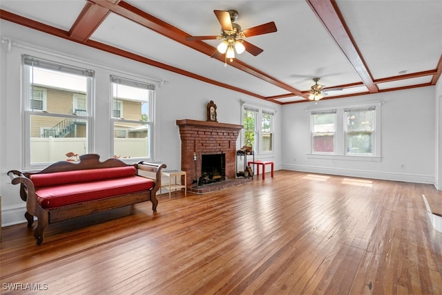 living room featuring a fireplace, coffered ceiling, ceiling fan, and hardwood / wood-style flooring