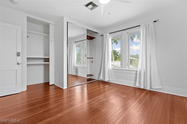 unfurnished bedroom featuring ceiling fan and hardwood / wood-style floors