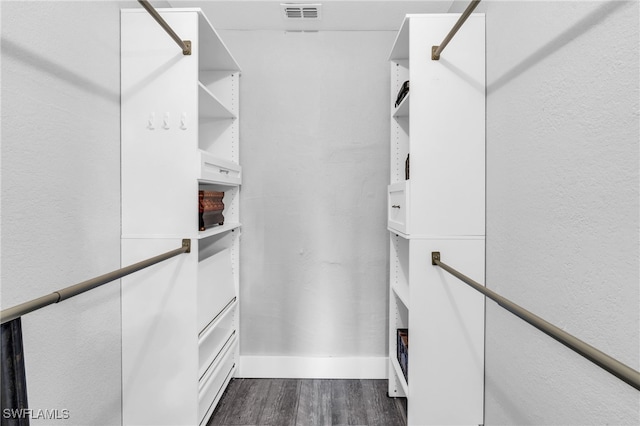 walk in closet featuring dark hardwood / wood-style floors