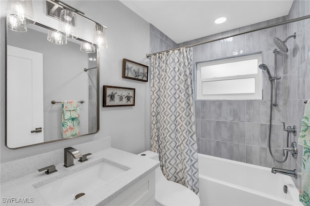 full bathroom featuring shower / bath combo with shower curtain, vanity, and toilet