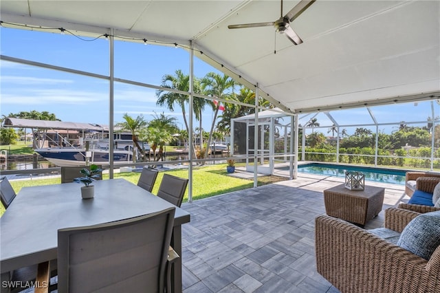 view of patio / terrace featuring glass enclosure and ceiling fan