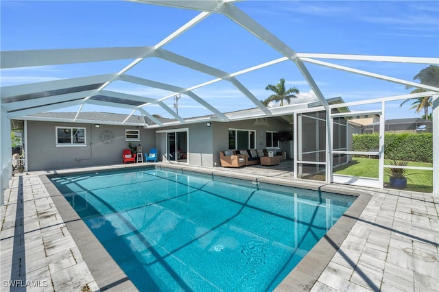 view of pool featuring outdoor lounge area, a patio area, and a lanai