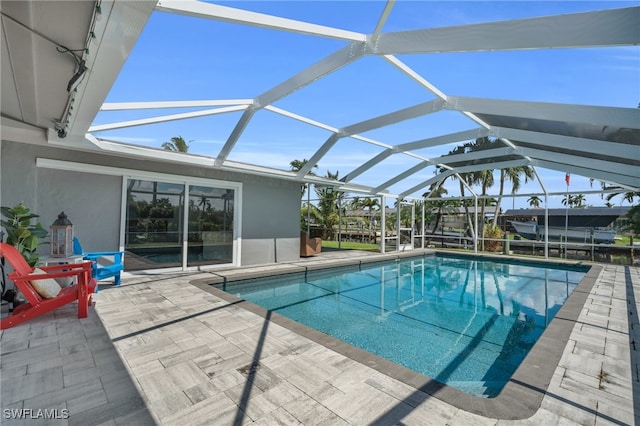 view of swimming pool with a lanai and a patio