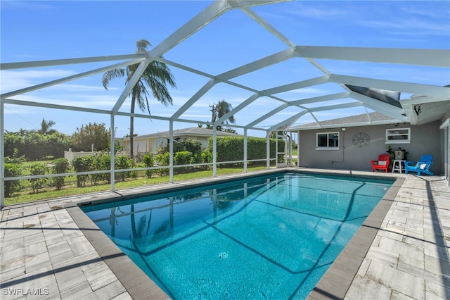 view of swimming pool with a lanai and a patio