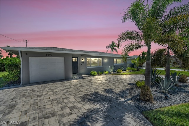 ranch-style home featuring a garage