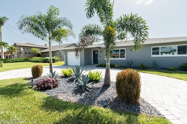 single story home with a front yard and a garage