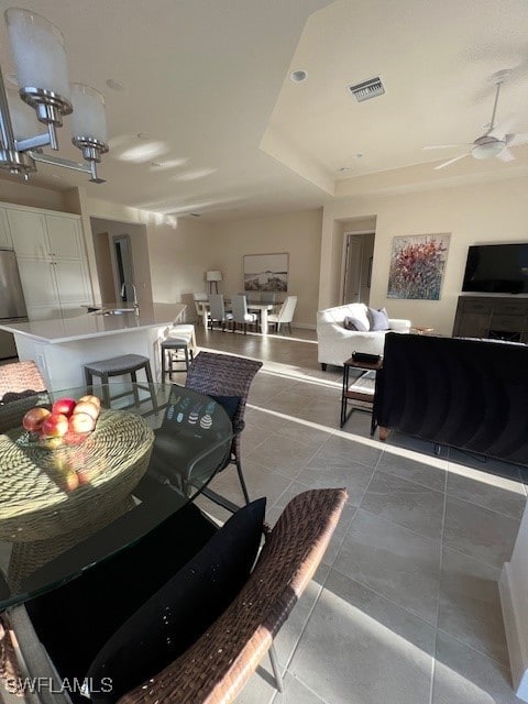 dining space featuring ceiling fan and tile patterned flooring