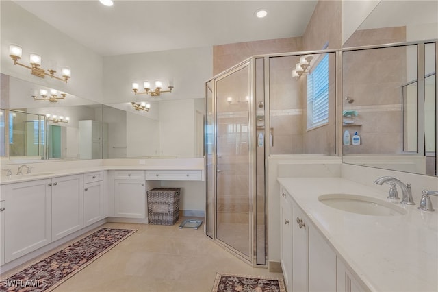 bathroom featuring vanity, a shower with shower door, and tile patterned flooring