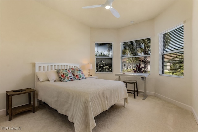 bedroom featuring ceiling fan and light colored carpet