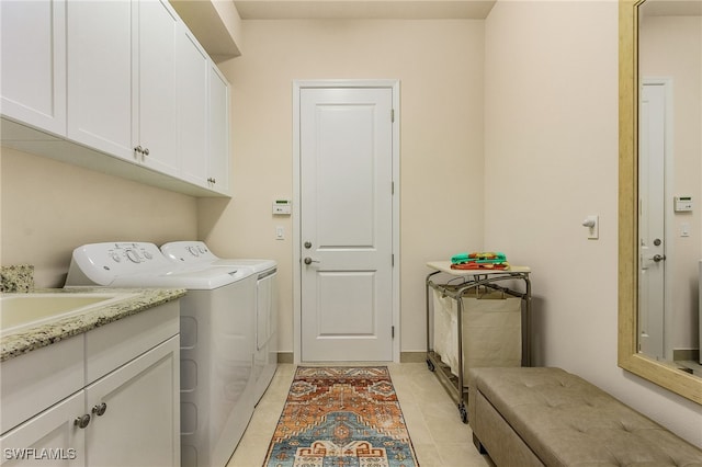 28777 Montecristo Loop, Bonita Springs, FL 34135 - washroom featuring washing machine and dryer, cabinet space, and light tile patterned floors