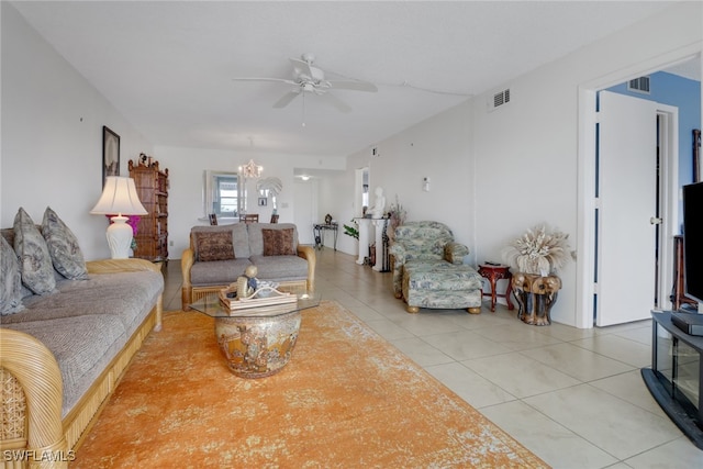 living room featuring ceiling fan with notable chandelier and tile patterned floors