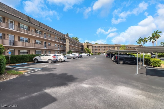 view of parking / parking lot featuring a carport