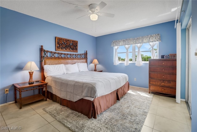 tiled bedroom with a textured ceiling and ceiling fan