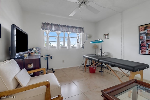 recreation room featuring light tile patterned floors and ceiling fan