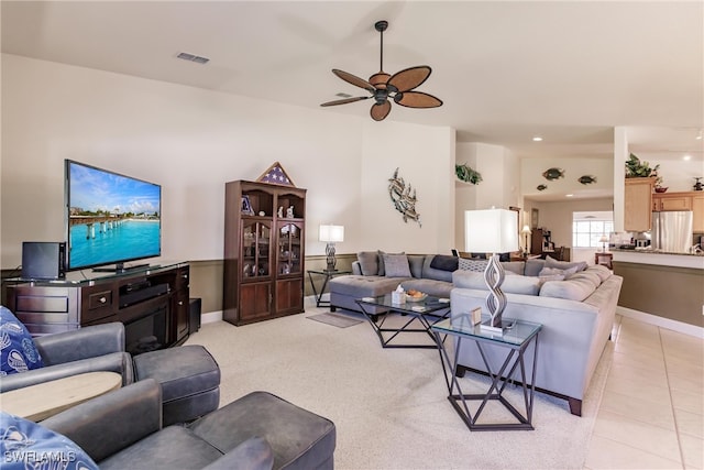 tiled living room featuring ceiling fan