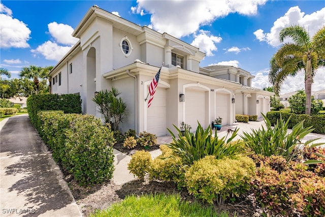 mediterranean / spanish-style home with a garage