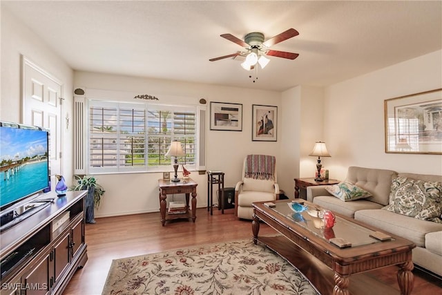 living room with ceiling fan and light hardwood / wood-style flooring