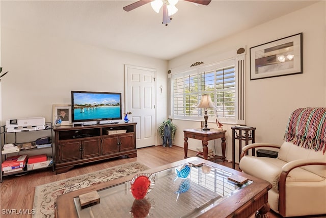 living room with hardwood / wood-style floors and ceiling fan