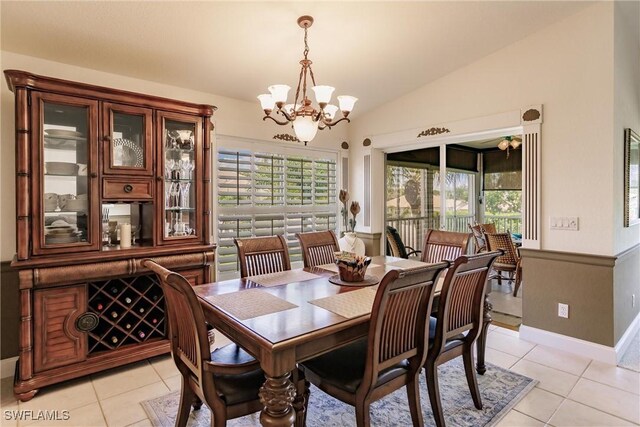 dining area featuring vaulted ceiling, light tile patterned floors, and a notable chandelier