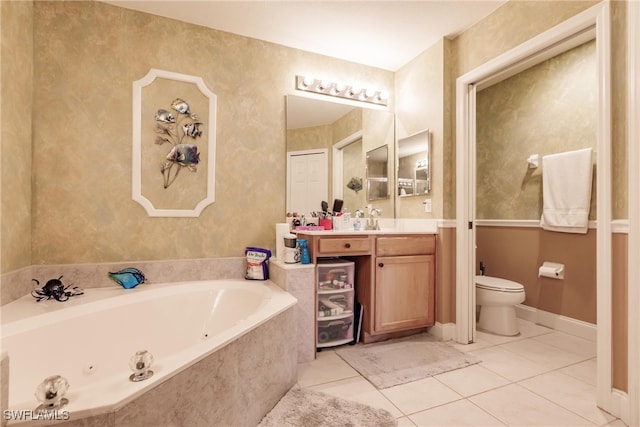 bathroom featuring vanity, tiled tub, tile patterned floors, and toilet