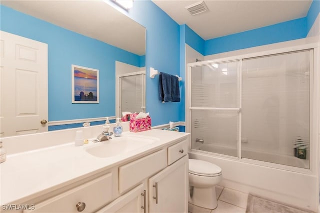 full bathroom with enclosed tub / shower combo, vanity, tile patterned floors, and toilet