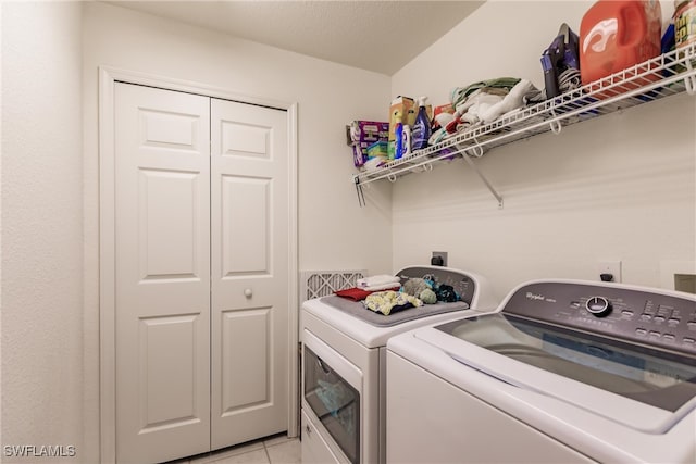 washroom with light tile patterned flooring and separate washer and dryer