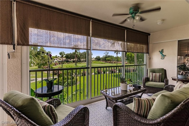 sunroom featuring ceiling fan