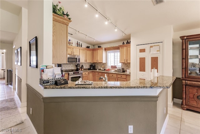 kitchen featuring light stone counters, light tile patterned floors, light brown cabinets, stainless steel appliances, and backsplash