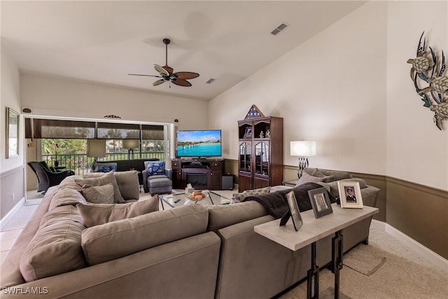 carpeted living room with vaulted ceiling and ceiling fan