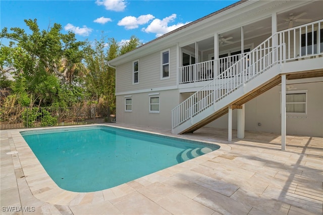 view of pool with a patio and ceiling fan