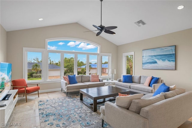 tiled living room featuring ceiling fan and high vaulted ceiling