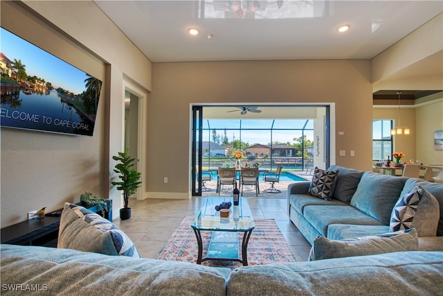 living room featuring ceiling fan with notable chandelier