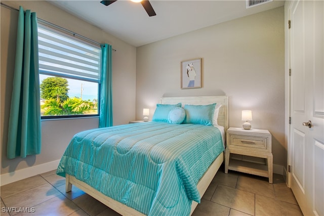 tiled bedroom featuring ceiling fan