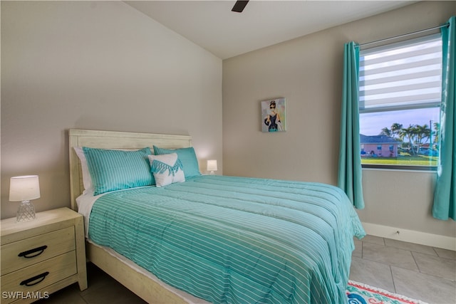 tiled bedroom featuring ceiling fan