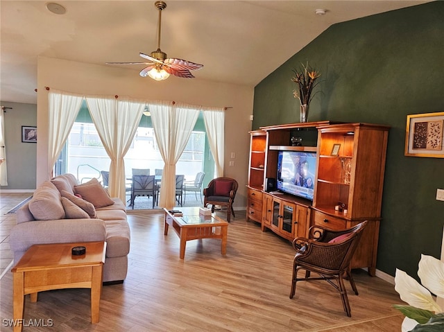 living room with ceiling fan, light wood-type flooring, and vaulted ceiling