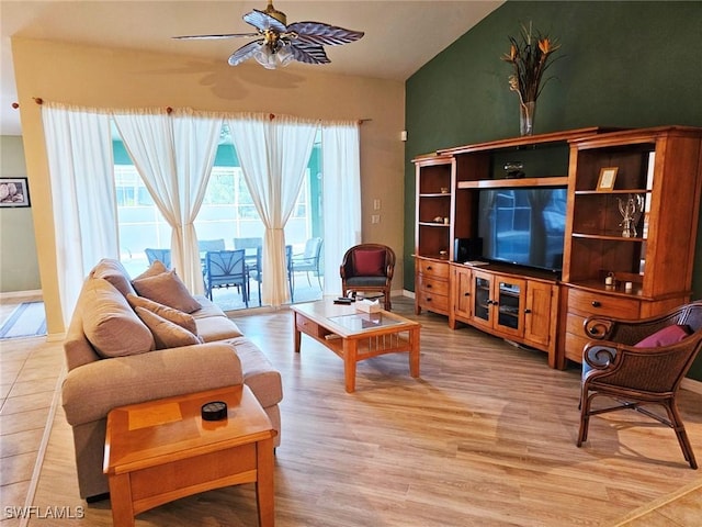 living room with ceiling fan, light hardwood / wood-style flooring, and lofted ceiling