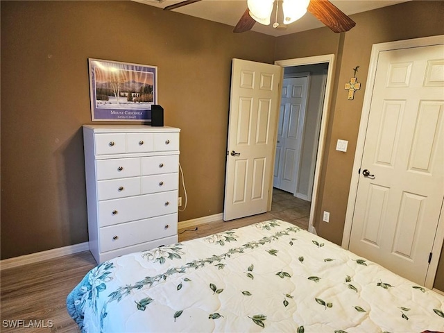 bedroom with ceiling fan and hardwood / wood-style floors